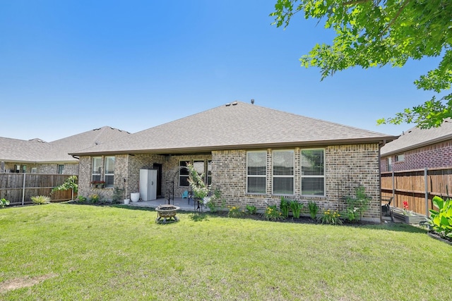1816 Dunstan Dr, Fort Worth, TX 76052 - back of property featuring a fire pit, brick siding, and roof with shingles