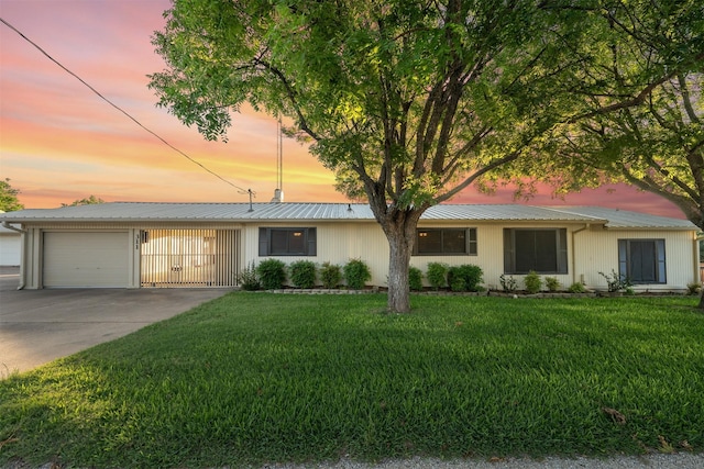 311 County Road 1710, Clifton, TX 76634 - ranch-style home with an attached garage, concrete driveway, a front lawn, and metal roof