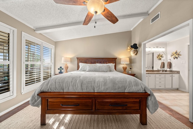 311 County Road 1710, Clifton, TX 76634 - bedroom featuring a textured ceiling, baseboards, connected bathroom, ceiling fan, and ornamental molding