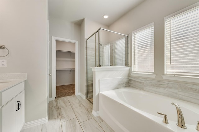6314 Catalpa Dr, Venus, TX 76084 - full bath featuring a stall shower, a garden tub, vanity, a walk in closet, and baseboards