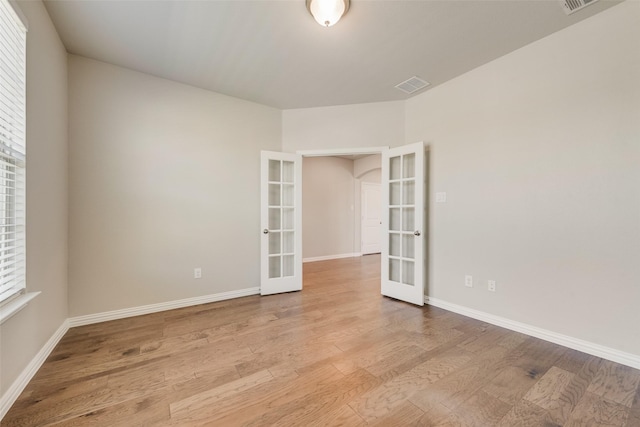 6314 Catalpa Dr, Venus, TX 76084 - empty room with french doors, wood finished floors, and baseboards