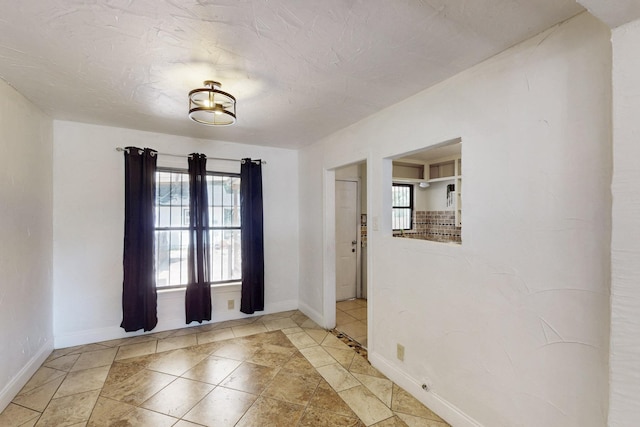 6725 Lovett Ave, Dallas, TX 75227 - tiled entryway with baseboards and healthy amount of natural light