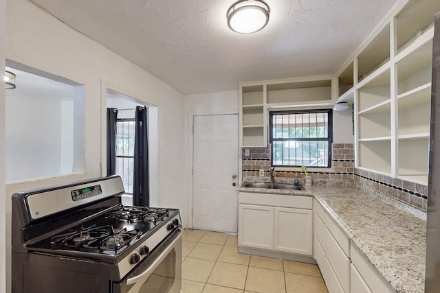 6725 Lovett Ave, Dallas, TX 75227 - kitchen with gas stove, open shelves, a sink, decorative backsplash, and light tile patterned flooring