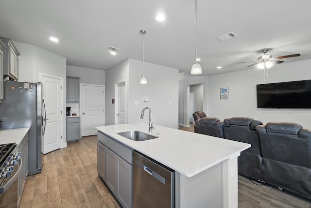 120 Texasage St, Rhome, TX 76078 - kitchen with a sink, gray cabinetry, appliances with stainless steel finishes, open floor plan, and recessed lighting