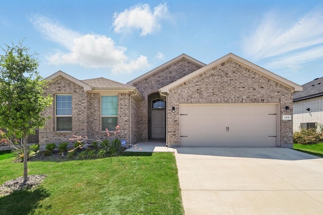 120 Texasage St, Rhome, TX 76078 - view of front of property with an attached garage, driveway, a front yard, and brick siding