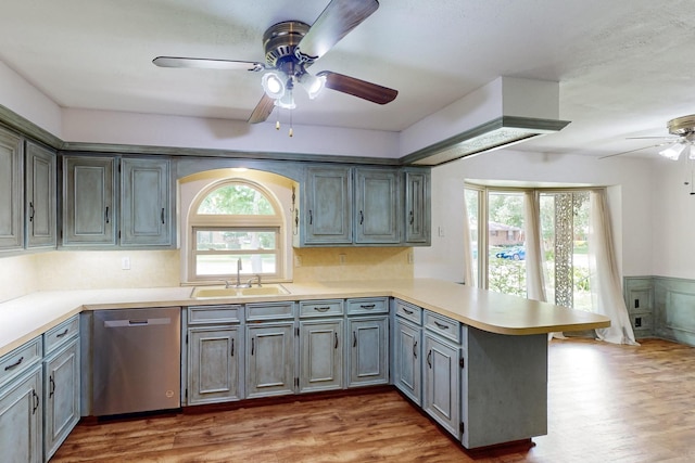 1308 Warwick St, Garland, TX 75040 - kitchen with dishwasher, a sink, a ceiling fan, a peninsula, and light countertops