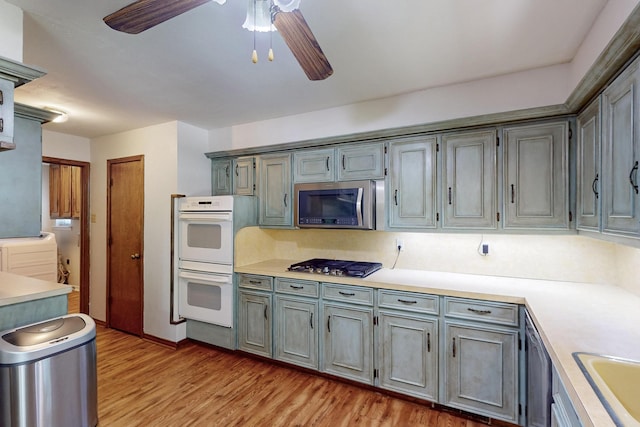 1308 Warwick St, Garland, TX 75040 - kitchen featuring appliances with stainless steel finishes, light countertops, light wood finished floors, and ceiling fan
