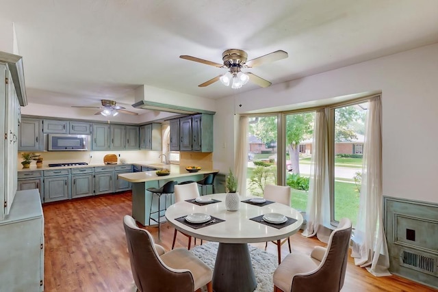 1308 Warwick St, Garland, TX 75040 - dining room with ceiling fan and light wood finished floors