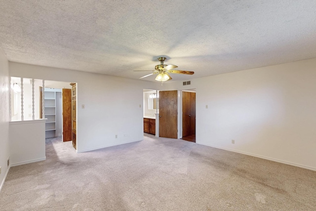 1308 Warwick St, Garland, TX 75040 - empty room with ceiling fan, light colored carpet, baseboards, and a textured ceiling