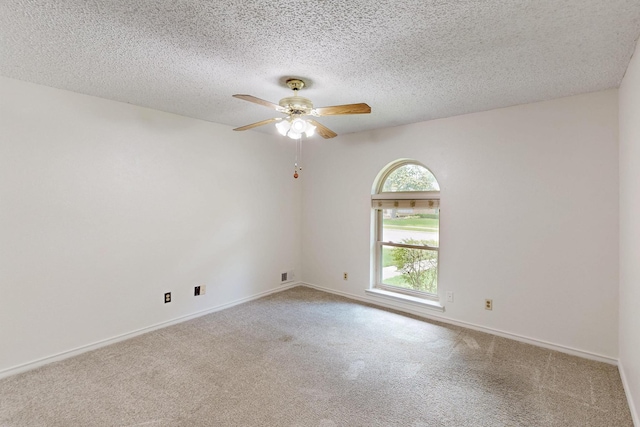 1308 Warwick St, Garland, TX 75040 - empty room with a ceiling fan, carpet, a textured ceiling, and baseboards
