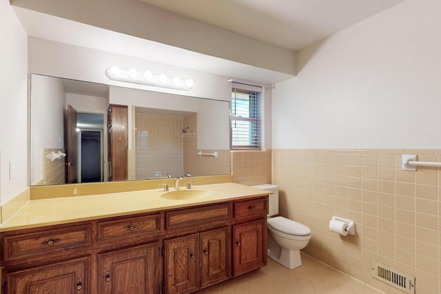 1308 Warwick St, Garland, TX 75040 - full bath featuring tile walls, toilet, tile patterned flooring, vanity, and a tile shower