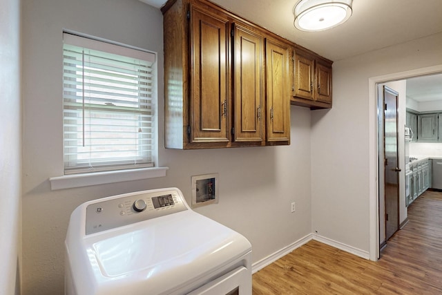 1308 Warwick St, Garland, TX 75040 - laundry room featuring washer / clothes dryer, cabinet space, light wood-type flooring, and baseboards