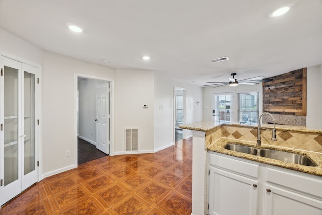 6108 Abrams Rd Unit 601, Dallas, TX 75231 - kitchen with a sink, recessed lighting, ceiling fan, tasteful backsplash, and white cabinetry