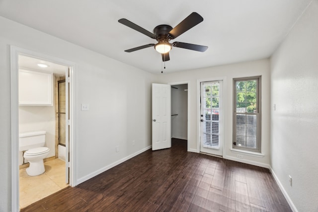6108 Abrams Rd Unit 601, Dallas, TX 75231 - unfurnished bedroom with dark wood-type flooring, ensuite bathroom, baseboards, access to outside, and ceiling fan