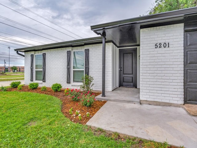 5201 Keller Cir, The Colony, TX 75056 - property entrance featuring brick siding and a yard