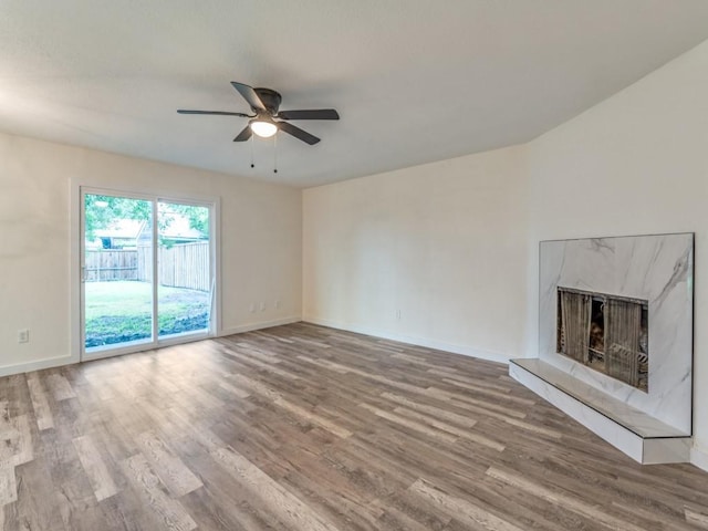 5201 Keller Cir, The Colony, TX 75056 - unfurnished living room with ceiling fan, wood finished floors, and baseboards