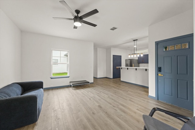 4706 Spring Ave, Dallas, TX 75210 - living room with ceiling fan, light wood-type flooring, and baseboards