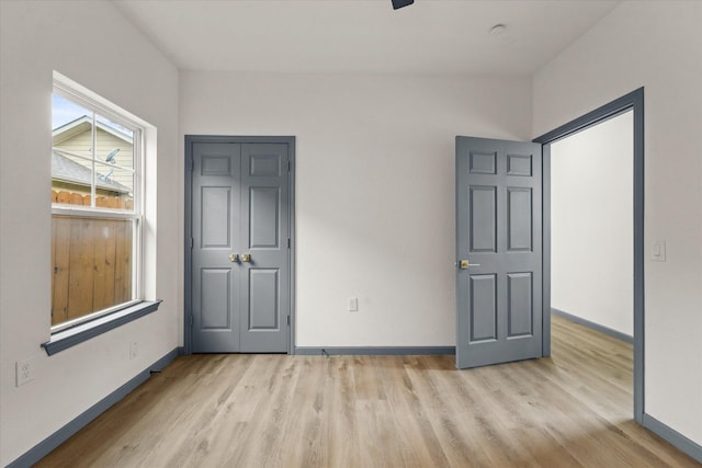 4706 Spring Ave, Dallas, TX 75210 - unfurnished bedroom featuring light wood-type flooring and baseboards