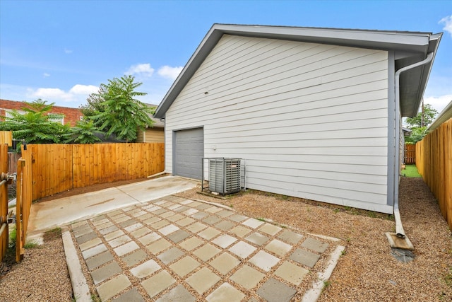 4706 Spring Ave, Dallas, TX 75210 - exterior space with a fenced backyard, central AC, driveway, a garage, and a patio