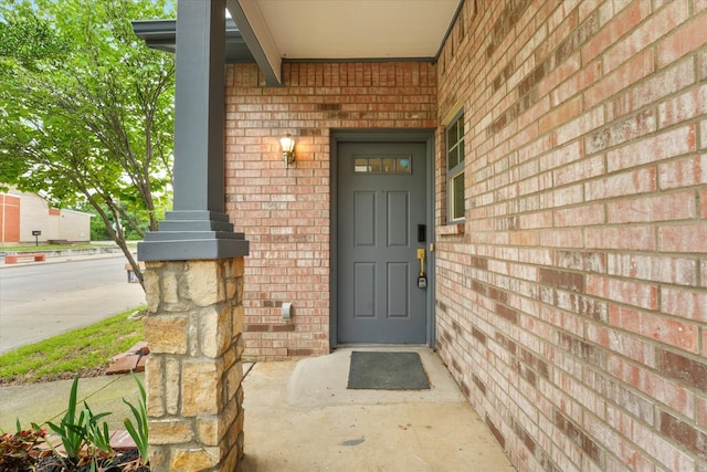 4706 Spring Ave, Dallas, TX 75210 - view of exterior entry featuring brick siding and a porch