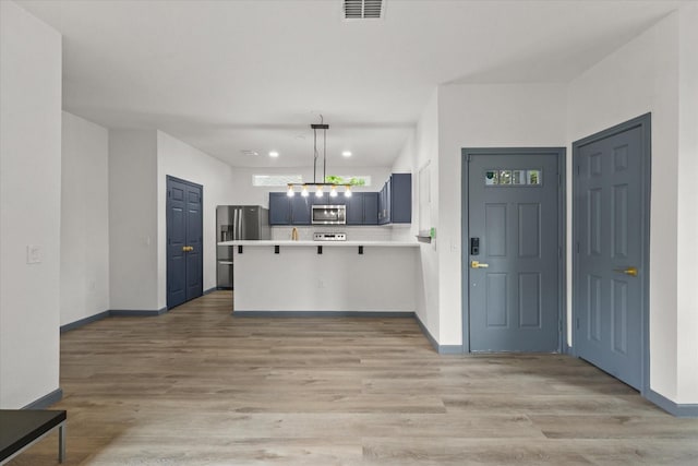 4706 Spring Ave, Dallas, TX 75210 - kitchen with stainless steel appliances, a peninsula, light countertops, baseboards, and recessed lighting