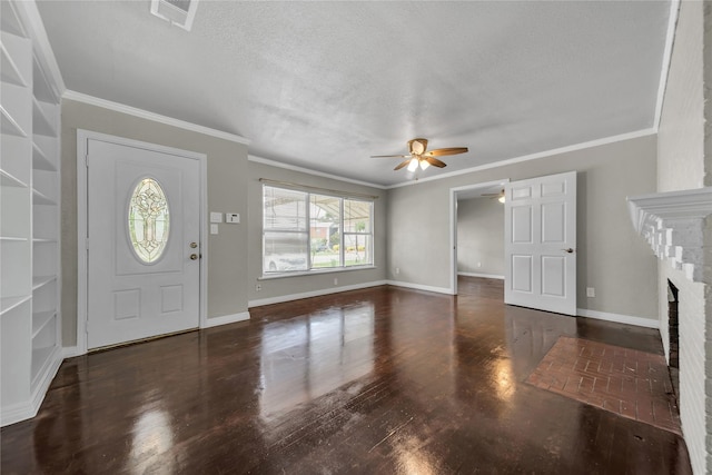 6423 Fisher Rd, Dallas, TX 75214 - foyer entrance featuring ceiling fan, crown molding, wood finished floors, a brick fireplace, and baseboards
