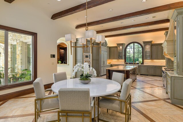 9996 Hollow Way Rd, Dallas, TX 75220 - dining area featuring beam ceiling, recessed lighting, baseboards, and arched walkways