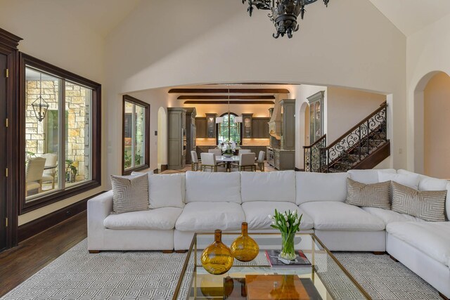 9996 Hollow Way Rd, Dallas, TX 75220 - living room featuring wood finished floors, arched walkways, a chandelier, stairs, and high vaulted ceiling