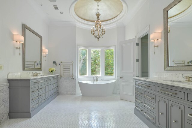 9996 Hollow Way Rd, Dallas, TX 75220 - full bathroom featuring crown molding, two vanities, a soaking tub, a chandelier, and a high ceiling