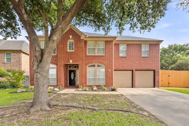 6952 Canyon Springs Rd, Fort Worth, TX 76132 - colonial-style house featuring a garage, concrete driveway, and brick siding