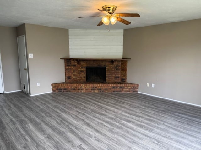 511 Hanover Dr, Allen, TX 75002 - unfurnished living room with a ceiling fan, wood finished floors, baseboards, and a brick fireplace