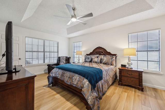 226 E Ridgegate Dr, Garland, TX 75040 - bedroom with baseboards, a textured ceiling, light wood-type flooring, and ceiling fan