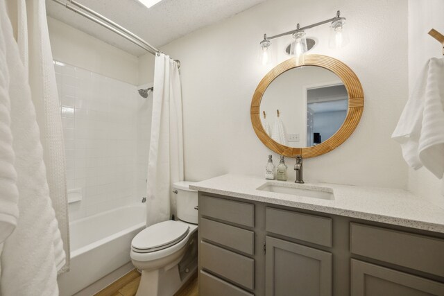 226 E Ridgegate Dr, Garland, TX 75040 - bathroom with vanity, shower / bathtub combination with curtain, toilet, and wood finished floors