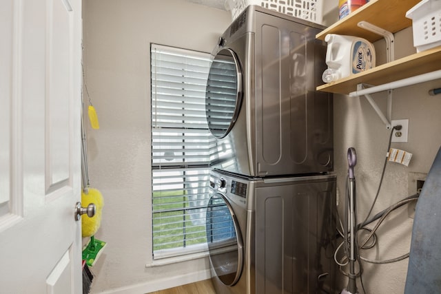 226 E Ridgegate Dr, Garland, TX 75040 - laundry room with stacked washer / drying machine and wood finished floors