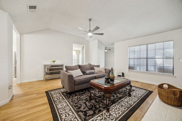226 E Ridgegate Dr, Garland, TX 75040 - living area with ceiling fan, vaulted ceiling, light wood finished floors, a textured ceiling, and baseboards