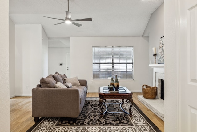 226 E Ridgegate Dr, Garland, TX 75040 - living area with wood finished floors, lofted ceiling, ceiling fan, a fireplace, and baseboards