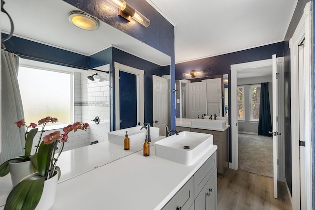 6821 Rochelle Dr, Plano, TX 75023 - bathroom with wood finished floors, a tile shower, vanity, and baseboards