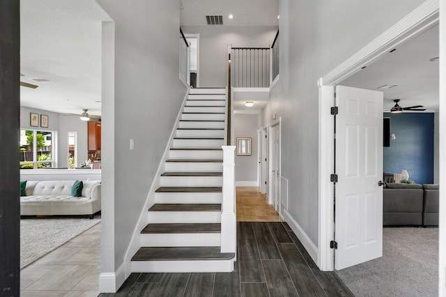 6821 Rochelle Dr, Plano, TX 75023 - staircase with ceiling fan, baseboards, wood finished floors, and a towering ceiling