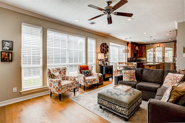 6712 E Park Dr, Fort Worth, TX 76132 - living room featuring ornamental molding, a ceiling fan, light wood-style flooring, baseboards, and recessed lighting