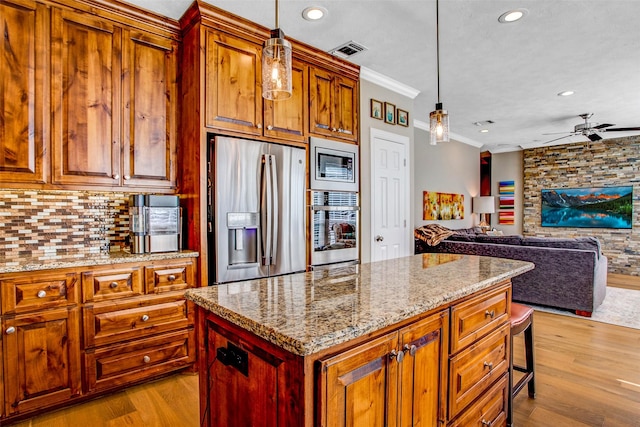 6712 E Park Dr, Fort Worth, TX 76132 - kitchen with stainless steel appliances, ornamental molding, wood finished floors, a ceiling fan, and recessed lighting