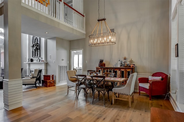 6712 E Park Dr, Fort Worth, TX 76132 - dining space featuring a high ceiling, wood finished floors, a chandelier, and baseboards