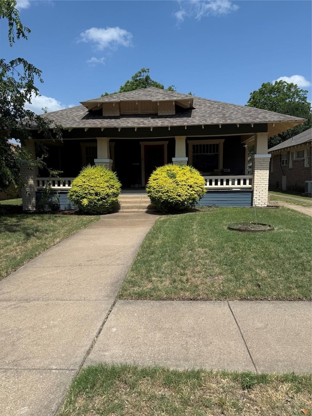 3105 S Adams St, Fort Worth, TX 76110 - view of front of house featuring a porch, a front yard, and roof with shingles