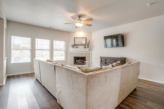 9861 Willowick Ave, Fort Worth, TX 76108 - living area with a ceiling fan, dark wood finished floors, baseboards, and a tiled fireplace