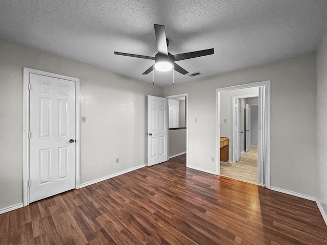 539 Mel Ct, Euless, TX 76039 - unfurnished bedroom with wood finished floors, baseboards, a textured ceiling, and a ceiling fan