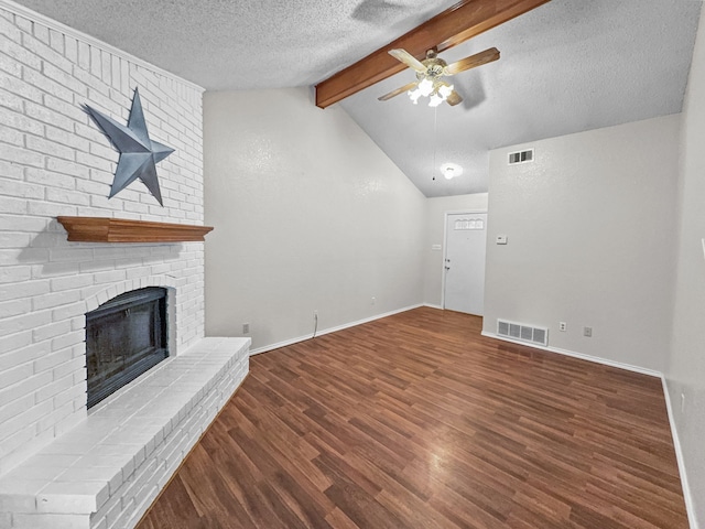 539 Mel Ct, Euless, TX 76039 - unfurnished living room with a ceiling fan, a textured ceiling, a brick fireplace, wood finished floors, and baseboards