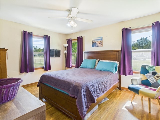 104 Sunny Ln, Athens, TX 75751 - bedroom featuring wood finished floors, ceiling fan, and baseboards