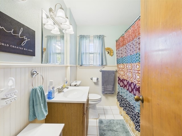 104 Sunny Ln, Athens, TX 75751 - full bath featuring vanity, toilet, tile patterned floors, a wainscoted wall, and a shower with shower curtain