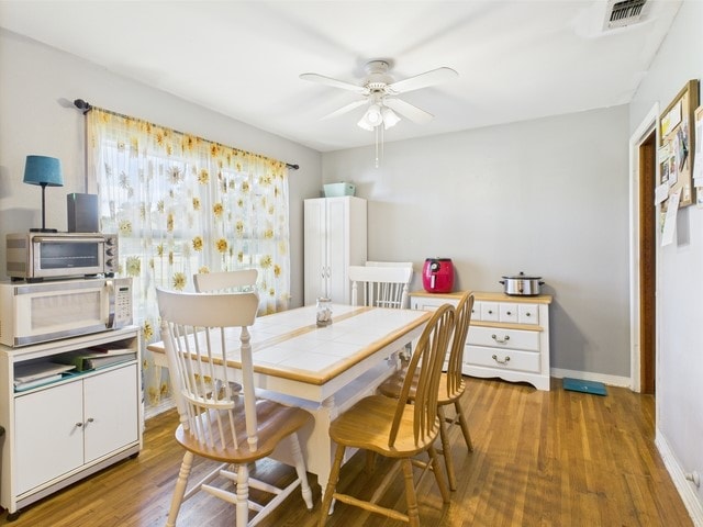 104 Sunny Ln, Athens, TX 75751 - dining space with ceiling fan, wood finished floors, and baseboards