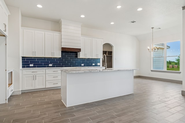 106 Maverick Way, Boyd, TX 76023 - kitchen with tasteful backsplash, white cabinetry, a center island with sink, light wood-style floors, and recessed lighting