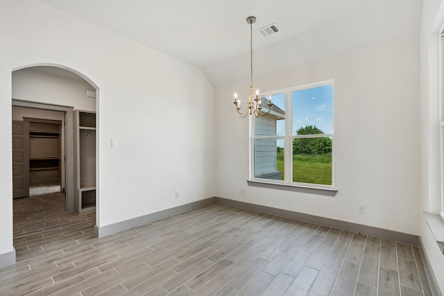 106 Maverick Way, Boyd, TX 76023 - unfurnished room with arched walkways, light wood-style floors, vaulted ceiling, baseboards, and a chandelier